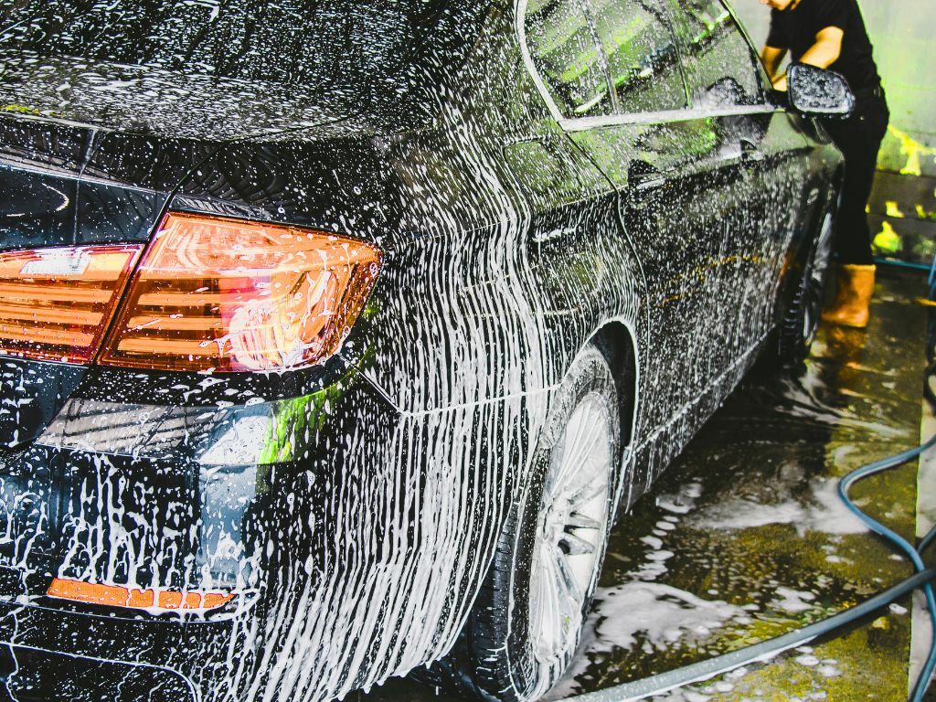 Person preparing a vehicle for shipping from New York by cleaning and removing personal items Person preparing a vehicle for shipping from New York by cleaning and removing personal items